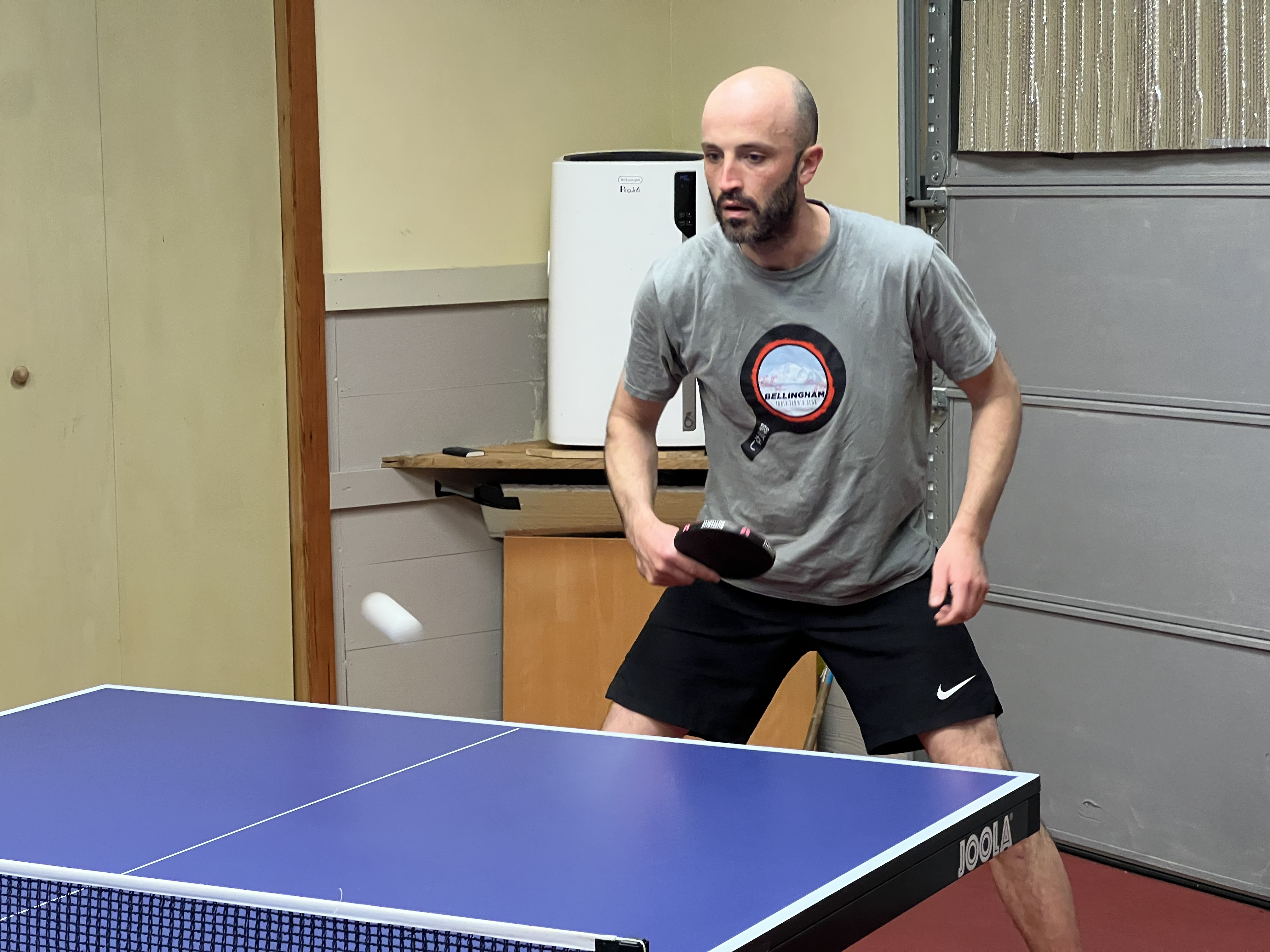 A table tennis backhand action shot at Bellingham Table Tennis Club